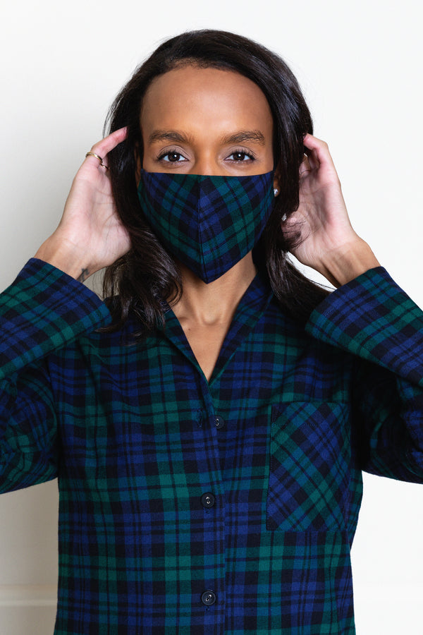 model wearing blackwatch tartan face mask and matching pajamas